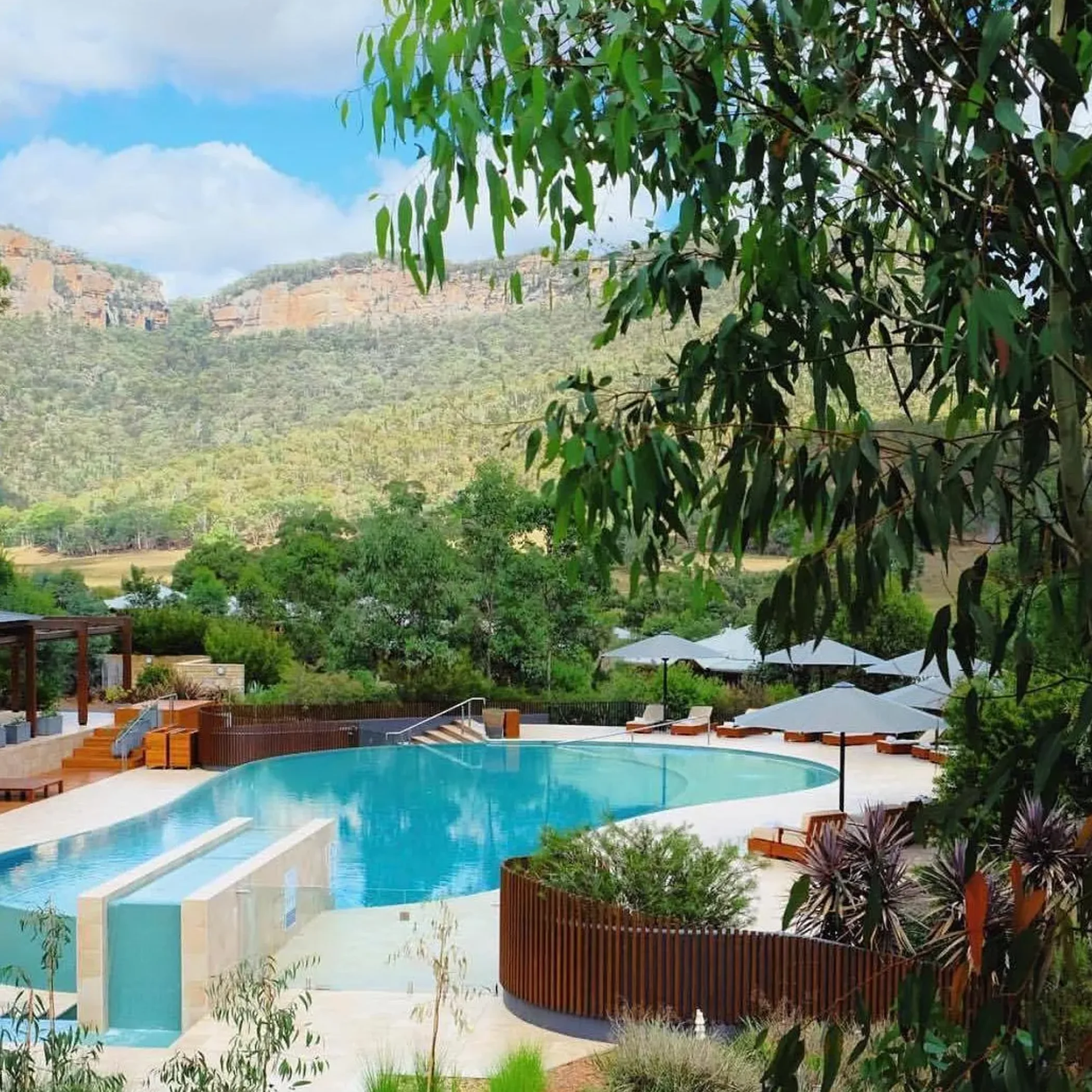 luxury resort pool with lounge chairs